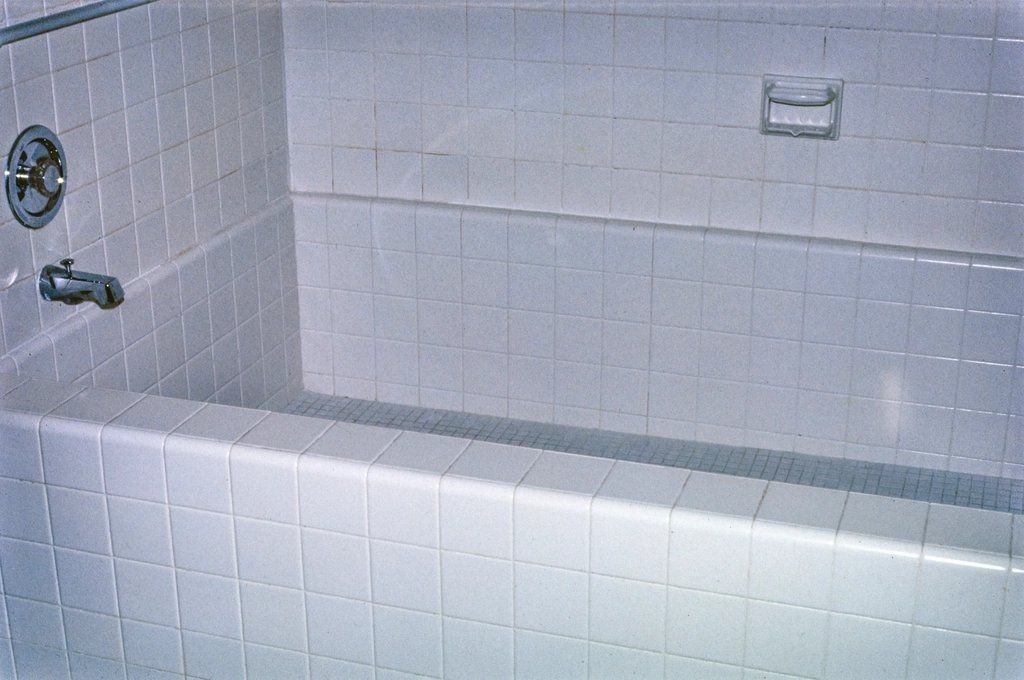 Close-up of white ceramic tile on a bathtub surround and wall